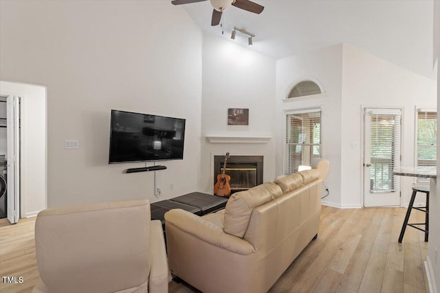 111 Killam Ct Unit 2A, Cary, NC 27513 - living area with high vaulted ceiling, track lighting, light wood-type flooring, ceiling fan, and a glass covered fireplace