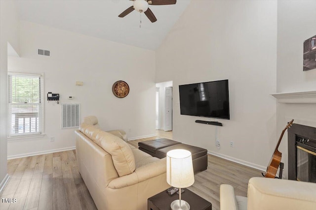 111 Killam Ct Unit 2A, Cary, NC 27513 - living room with high vaulted ceiling, wood finished floors, a ceiling fan, baseboards, and a glass covered fireplace