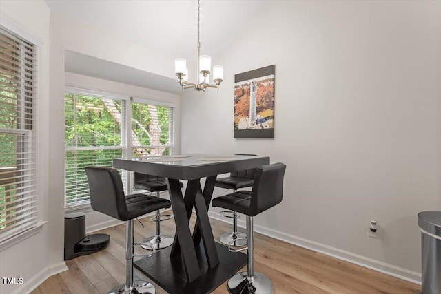 111 Killam Ct Unit 2A, Cary, NC 27513 - dining space with baseboards, a chandelier, light wood-style flooring, and lofted ceiling