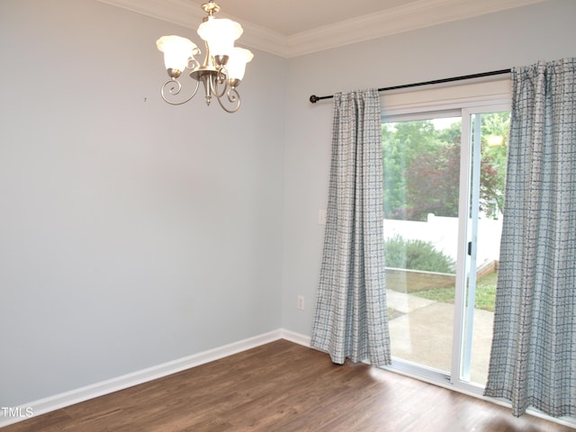 unfurnished dining area featuring crown molding, a chandelier, wood finished floors, and baseboards