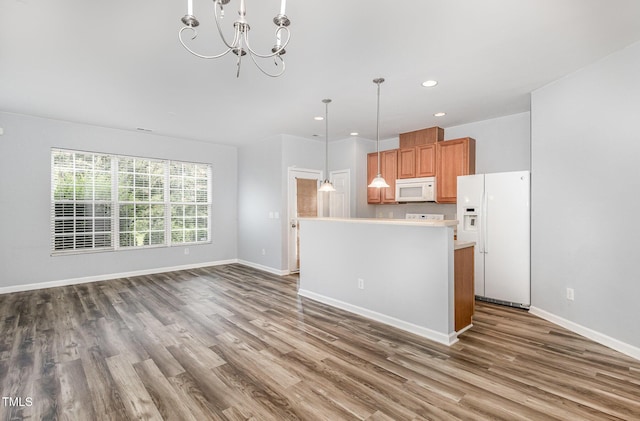 958 Shining Wire Way, Morrisville, NC 27560 - kitchen with white appliances, wood finished floors, recessed lighting, decorative light fixtures, and a chandelier