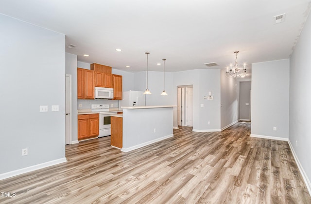 958 Shining Wire Way, Morrisville, NC 27560 - kitchen featuring white appliances, light countertops, light wood-style flooring, a chandelier, and recessed lighting