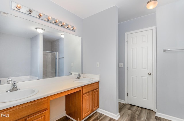 958 Shining Wire Way, Morrisville, NC 27560 - bathroom featuring double vanity, a shower stall, wood finished floors, and a tub
