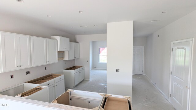 kitchen featuring white cabinetry and baseboards