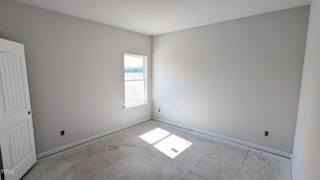 empty room featuring baseboards