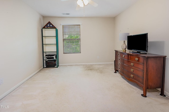 bedroom featuring light carpet, baseboards, and ceiling fan