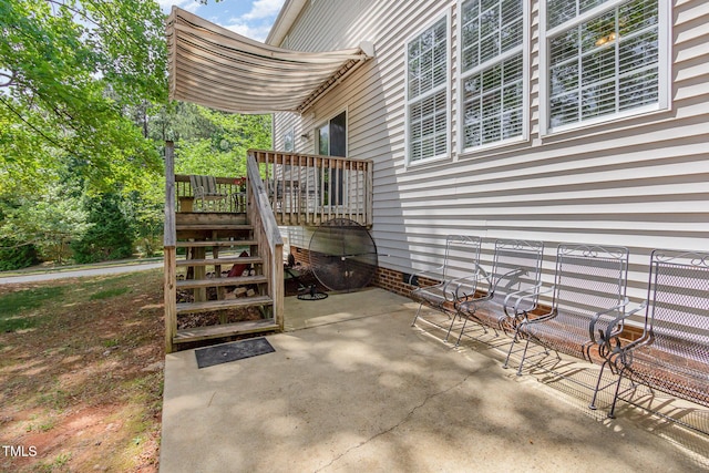 view of patio / terrace featuring a deck and stairway