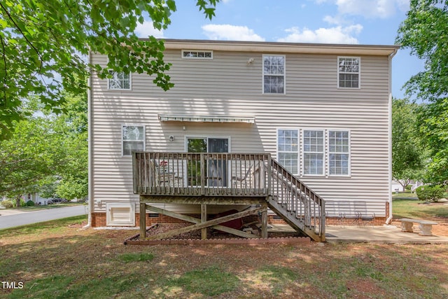 rear view of house with a deck and a patio