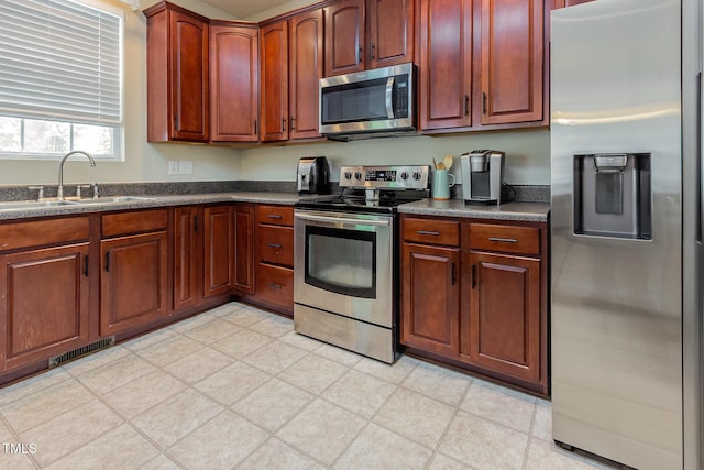 kitchen featuring appliances with stainless steel finishes and a sink