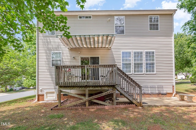 rear view of property with a deck, a patio, and stairs