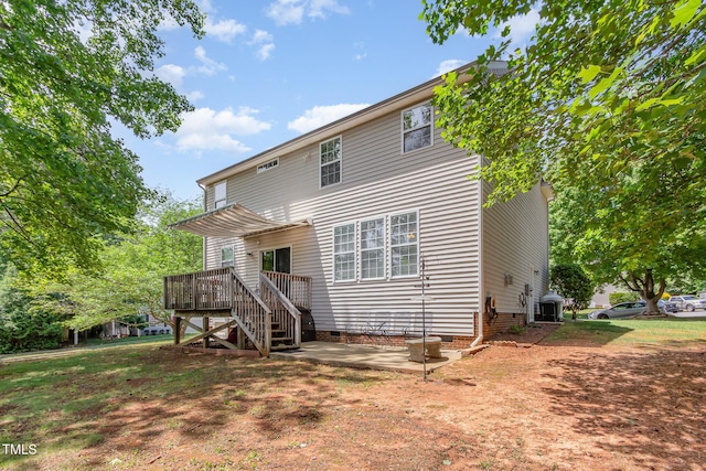 rear view of house featuring crawl space, a patio, a wooden deck, and stairs