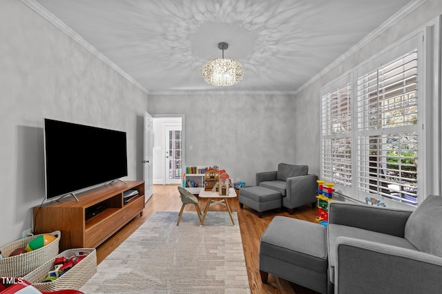 120 Harmony Hill Ln, Cary, NC 27513 - living room with wood finished floors, a chandelier, and crown molding