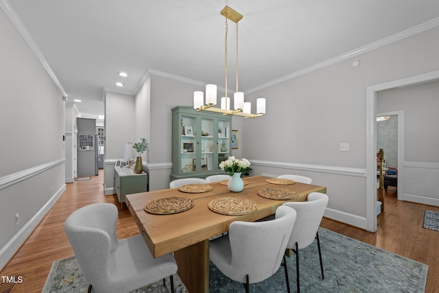 120 Harmony Hill Ln, Cary, NC 27513 - dining area with a chandelier, ornamental molding, wood finished floors, recessed lighting, and baseboards