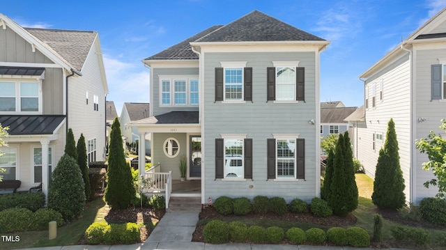 view of front of home featuring covered porch and a shingled roof