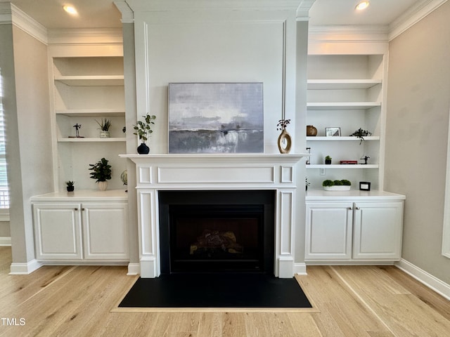 1641 Silo Ridge Dr, Wake Forest, NC 27587 - living room with light wood finished floors, built in shelves, ornamental molding, a fireplace with flush hearth, and baseboards