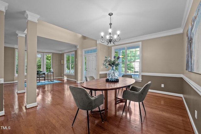 dining space with plenty of natural light, baseboards, wood finished floors, and ornamental molding