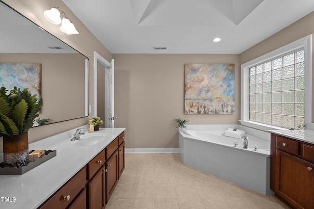 bathroom featuring baseboards, vanity, a bath, recessed lighting, and tile patterned floors
