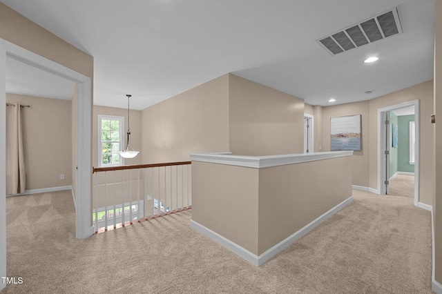 hall with light carpet, baseboards, and recessed lighting