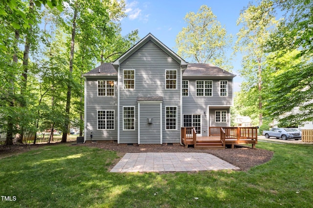 back of property featuring a yard, a patio area, a wooden deck, and cooling unit