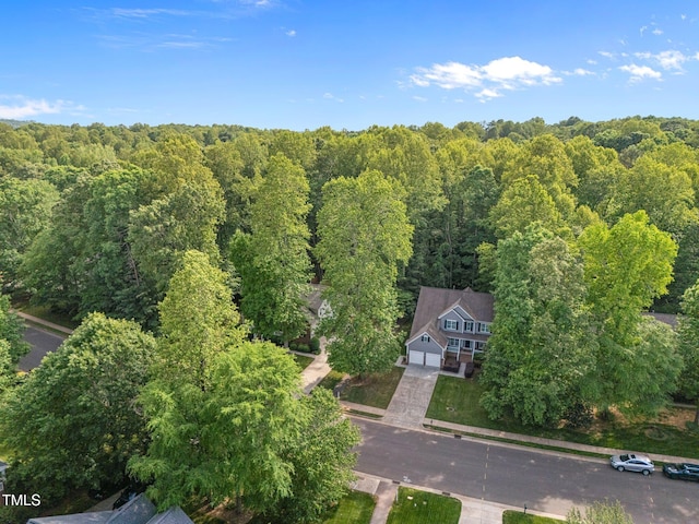 view from above of property with a heavily wooded area