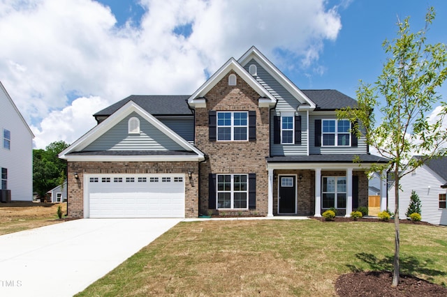 50 Rosewood Ln, Youngsville, NC 27596 - craftsman inspired home featuring driveway, a front yard, an attached garage, and brick siding
