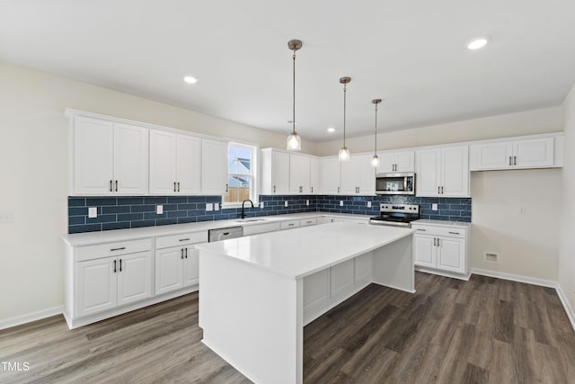 50 Rosewood Ln, Youngsville, NC 27596 - kitchen featuring stainless steel appliances, a sink, dark wood-type flooring, white cabinetry, and recessed lighting