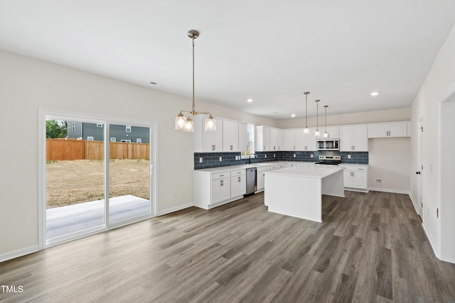 50 Rosewood Ln, Youngsville, NC 27596 - kitchen with stainless steel appliances, tasteful backsplash, white cabinetry, dark wood-style floors, and recessed lighting