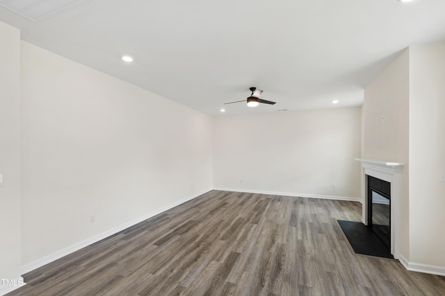 50 Rosewood Ln, Youngsville, NC 27596 - unfurnished living room featuring wood finished floors, ceiling fan, recessed lighting, a glass covered fireplace, and baseboards