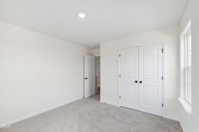 50 Rosewood Ln, Youngsville, NC 27596 - unfurnished bedroom with light carpet, baseboards, a closet, and recessed lighting
