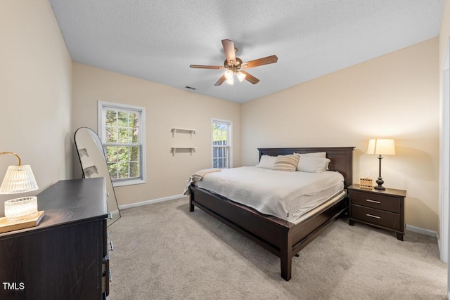 bedroom featuring light carpet, baseboards, and a ceiling fan