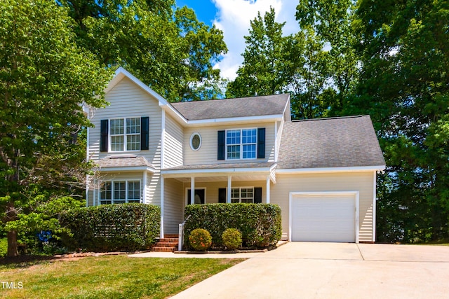 716 Lakeview Ave, Wake Forest, NC 27587 - traditional home featuring a porch, a garage, concrete driveway, roof with shingles, and a front yard
