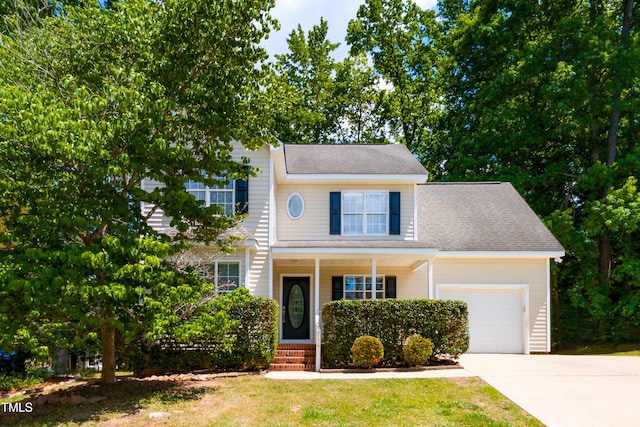 716 Lakeview Ave, Wake Forest, NC 27587 - view of front of house featuring a garage, driveway, covered porch, roof with shingles, and a front lawn