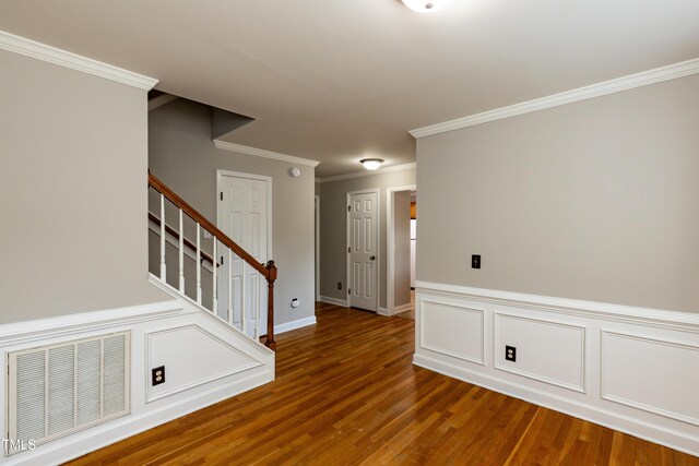 716 Lakeview Ave, Wake Forest, NC 27587 - entrance foyer with wood finished floors, crown molding, and stairs