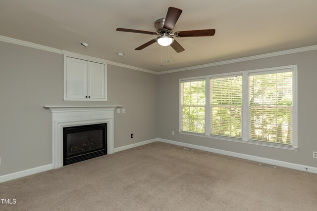 716 Lakeview Ave, Wake Forest, NC 27587 - unfurnished living room featuring a glass covered fireplace, baseboards, crown molding, light carpet, and ceiling fan