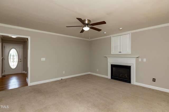 716 Lakeview Ave, Wake Forest, NC 27587 - unfurnished living room with a ceiling fan, carpet floors, baseboards, a glass covered fireplace, and ornamental molding