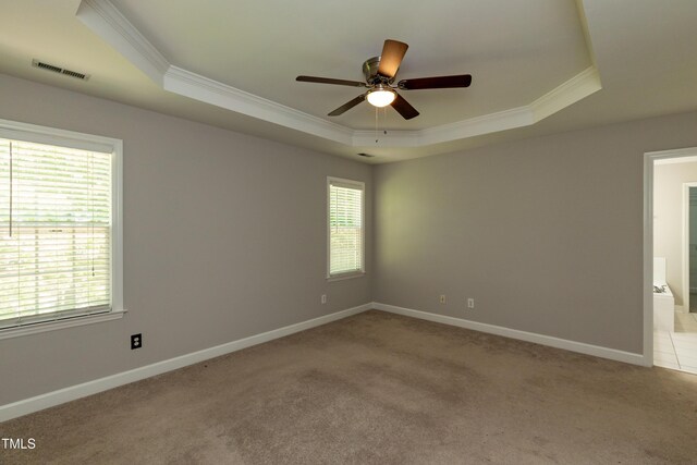 716 Lakeview Ave, Wake Forest, NC 27587 - spare room featuring a tray ceiling, crown molding, a ceiling fan, light colored carpet, and baseboards