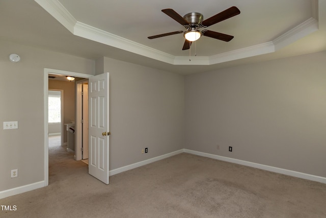 716 Lakeview Ave, Wake Forest, NC 27587 - unfurnished room featuring a raised ceiling, ornamental molding, light colored carpet, a ceiling fan, and baseboards