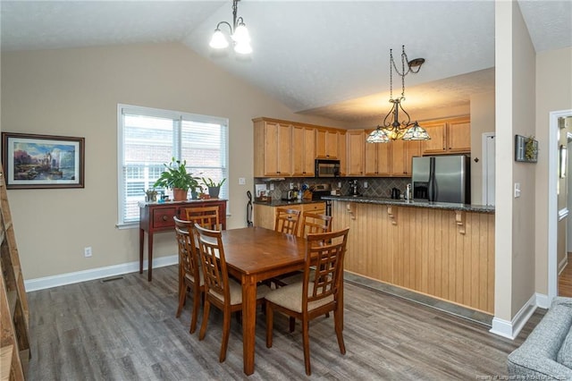 3024 Metthame Dr, Fayetteville, NC 28306 - dining area featuring a chandelier, wood finished floors, lofted ceiling, and baseboards