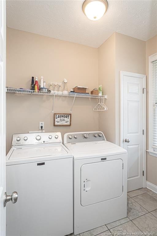 3024 Metthame Dr, Fayetteville, NC 28306 - clothes washing area featuring washing machine and dryer, a textured ceiling, and baseboards