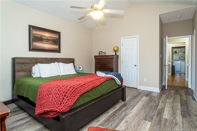 3024 Metthame Dr, Fayetteville, NC 28306 - bedroom with washing machine and dryer, wood finished floors, vaulted ceiling, baseboards, and a ceiling fan