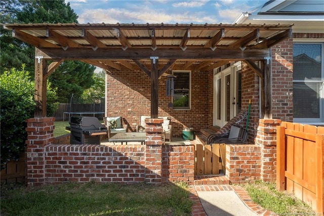 3024 Metthame Dr, Fayetteville, NC 28306 - view of patio featuring a trampoline, fence, and area for grilling