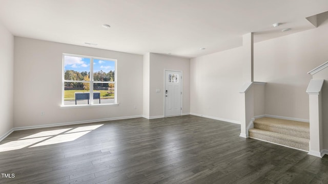 826 Old Tarboro Rd, Wendell, NC 27591 - unfurnished living room featuring stairs, dark wood-style flooring, and baseboards
