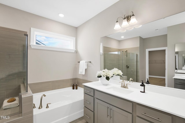 full bathroom featuring a stall shower, a walk in closet, vanity, a bath, and recessed lighting