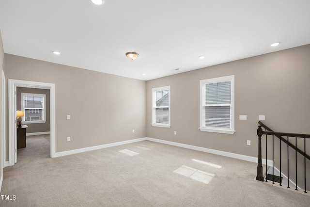 unfurnished room with light carpet, baseboards, and recessed lighting