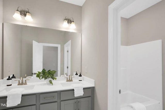 full bathroom featuring double vanity and shower / washtub combination