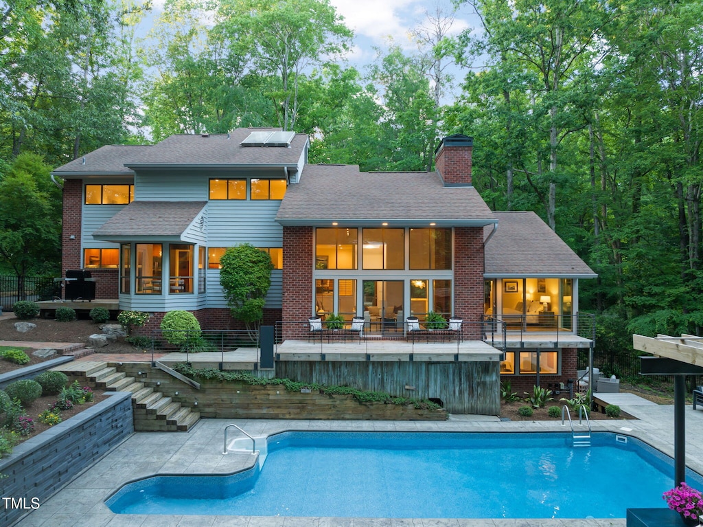 3910 Somerset Dr, Durham, NC 27707 - back of property featuring stairway, a chimney, an outdoor pool, and a patio