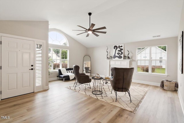 1969 Bowles Ave, Creedmoor, NC 27522 - living area featuring vaulted ceiling, a fireplace, wood finished floors, a ceiling fan, and baseboards