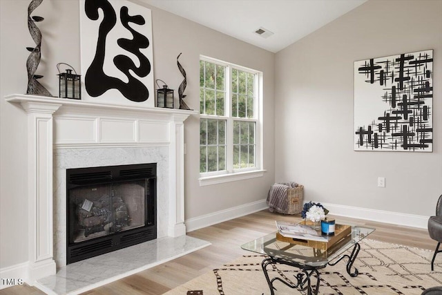 1969 Bowles Ave, Creedmoor, NC 27522 - living area with light wood-type flooring, a premium fireplace, lofted ceiling, and baseboards