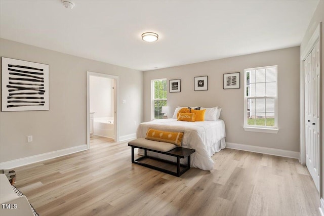 1969 Bowles Ave, Creedmoor, NC 27522 - bedroom featuring light wood-type flooring, a closet, baseboards, and ensuite bathroom