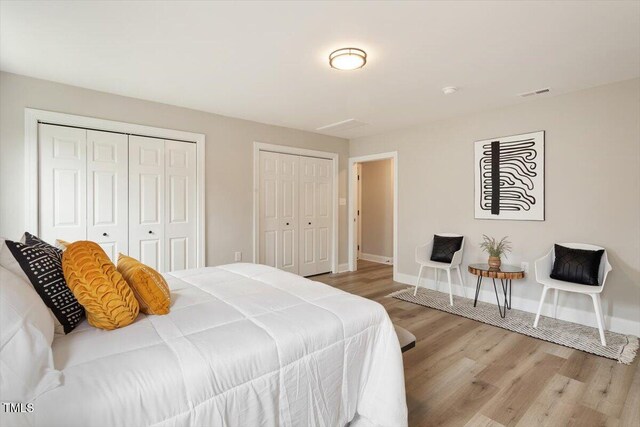 1969 Bowles Ave, Creedmoor, NC 27522 - bedroom featuring multiple closets, wood finished floors, and baseboards